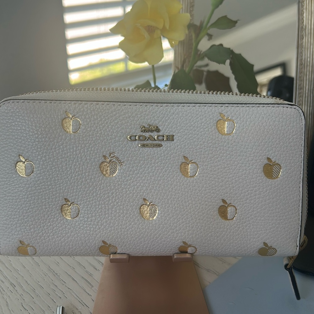 COACH- Accordion Zip Wallet with Apple Print in Gold.